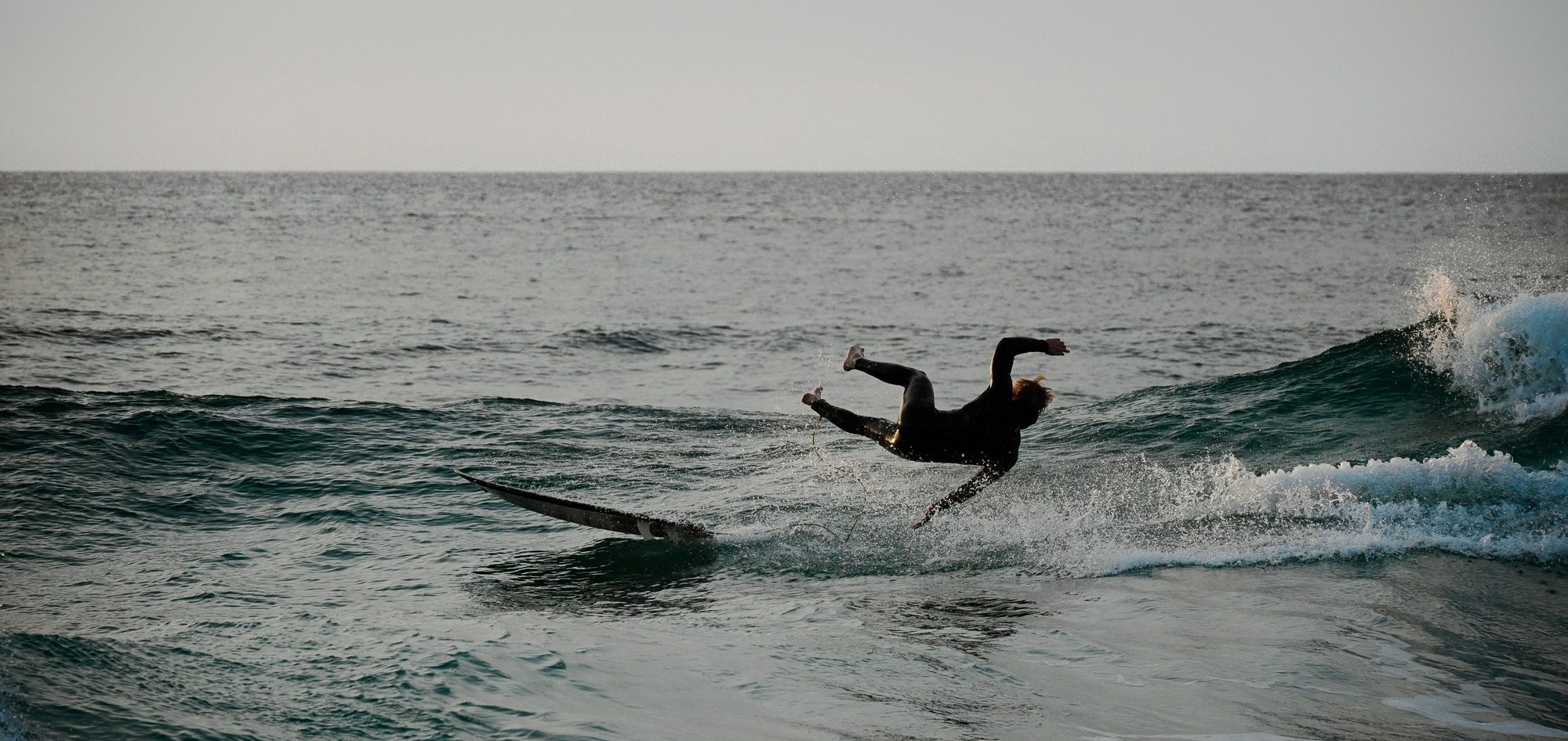 Surfer Falls off his wave